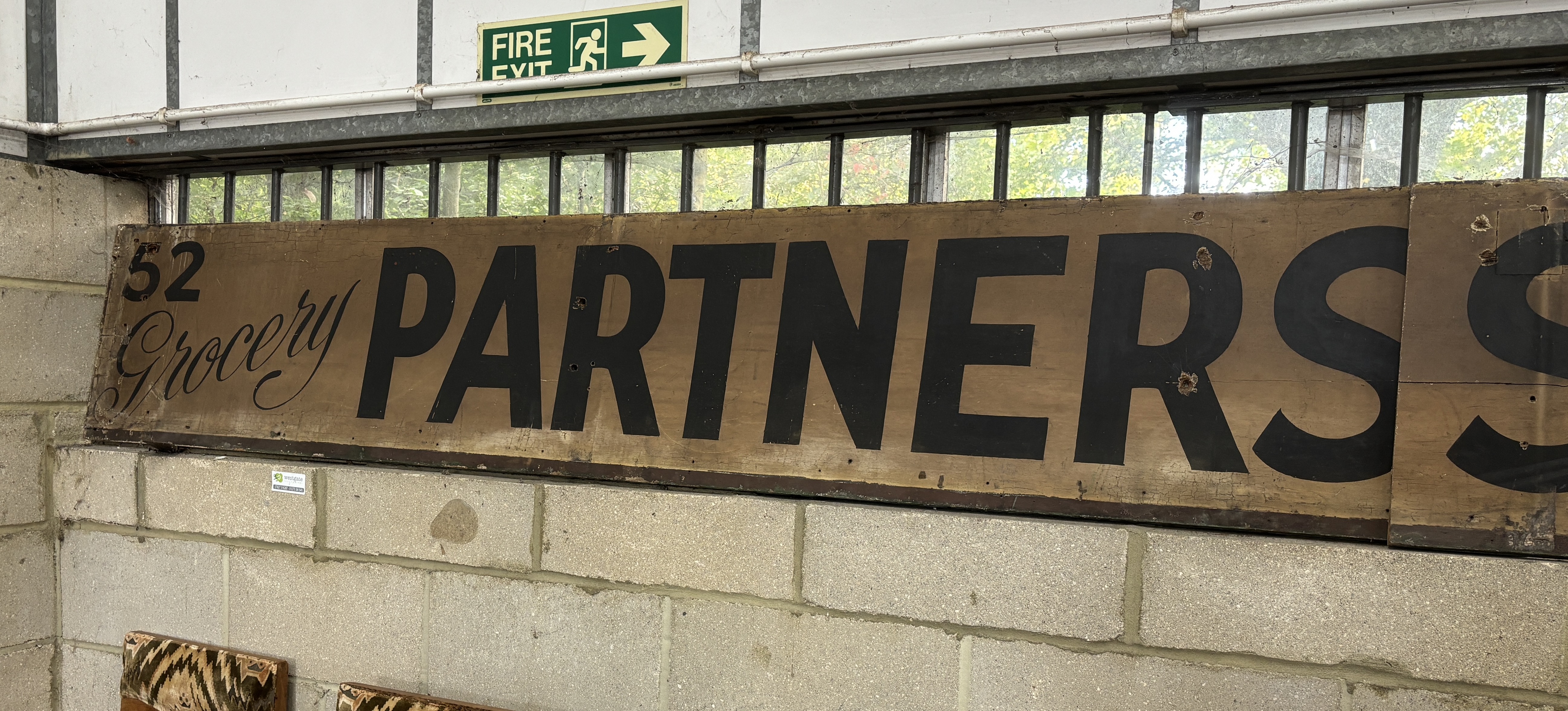 A vintage Partners Stores Limited shop sign, combined length approx. 540cm, height 44cm